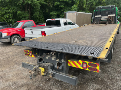 Tread plating welded onto a flatbed tow truck for additional traction when loading vehicles. Access holes were cut to allow for proper clearance for chains and hooks.