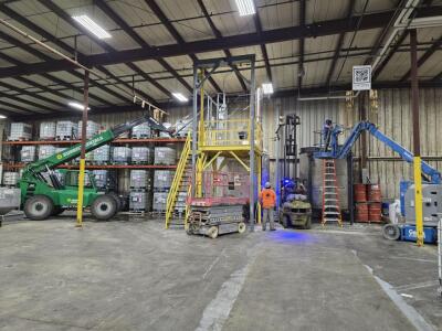 Custom steel mixer platform with a guillotine style gate and Hoist Frame. Designed, engineered, fabricated and installed by M&M