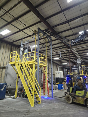 Custom steel mixer platform with a guillotine style gate and Hoist Frame. Designed, engineered, fabricated and installed by M&M