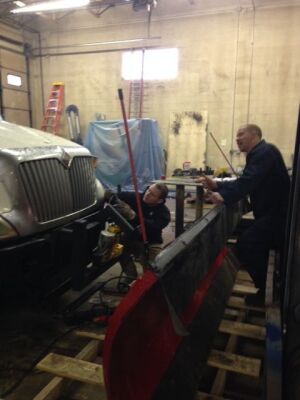 Welders working on truck