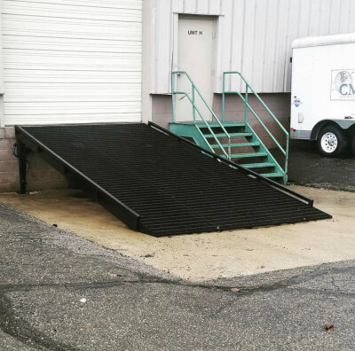 Custom fabricated grated steel ramp for a loading dock at a local business
